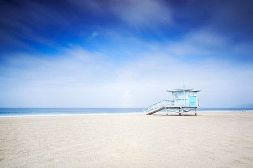 A lifeguard hut on a white sand beach