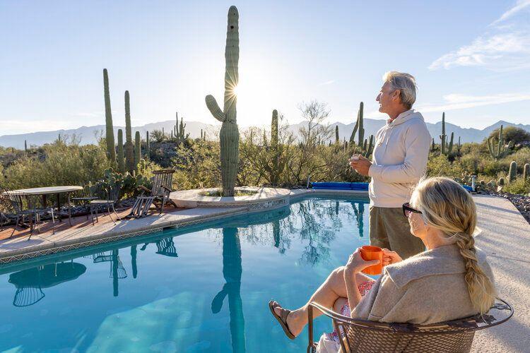 The best time to visit Arizona, couple enjoy the scenery from their private rental with pool, Top Villas