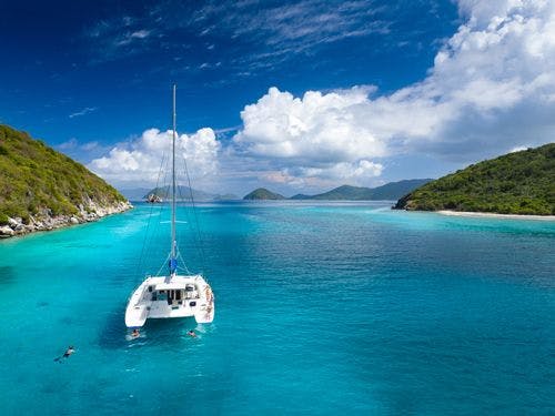 A catamaran moored on a reef in the Caribbean