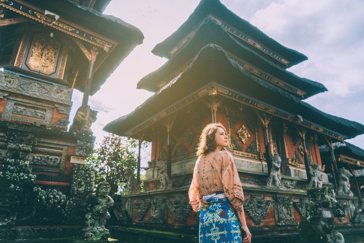 A lady takes in the sights as she goes on a temple tour in Bali