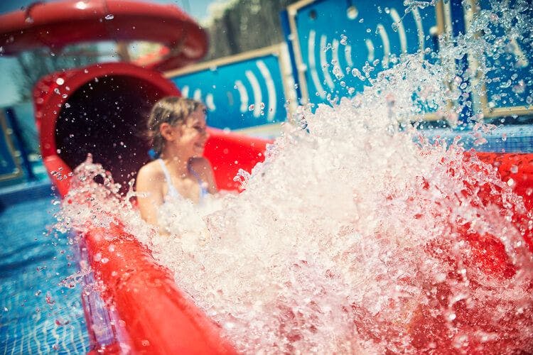 A child enjoys a water slide