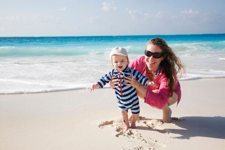 A mum and toddler enjoy Chalk Sound Beach in Turks & Caicos