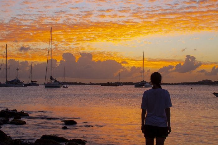 A lady takes in the sunset over Grand Case St Martin