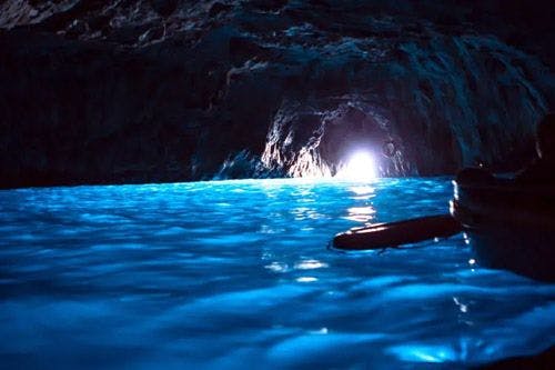 Blue sea water inside a dark cave