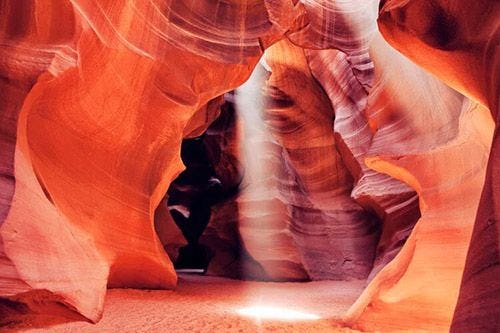 Sunlight streaming through a gap in the top of Antelope Canyon