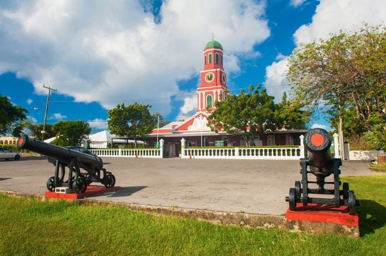 Bridgetown Garrison, a historic building in Barbados with canons guarding a pink-colored clock tower