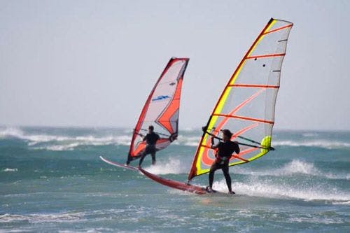 Two windsurfers on a choppy sea