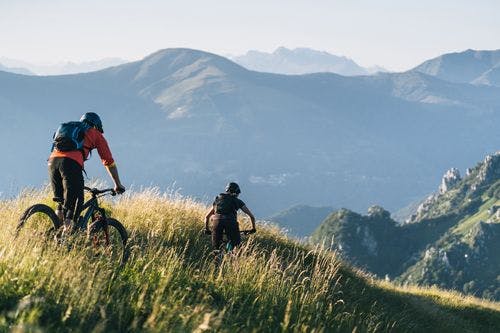 Two people mountain biking