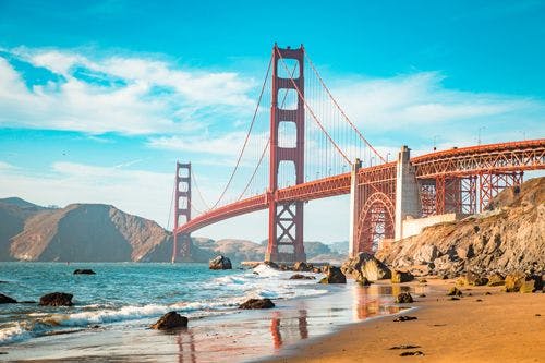 Golden Gate Bridge in San Francisco with golden sand beach beneath