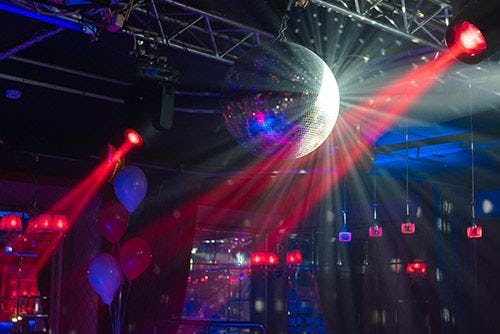 A disco ball reflecting light inside a nightclub