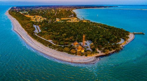 Drone shot of Sanibel Island with white beaches and green interior