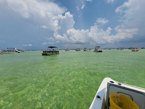 View from the front of a small boat of the clear water at Crab Island, Destin