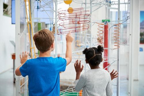 Two children looking at an exhibit in a science center