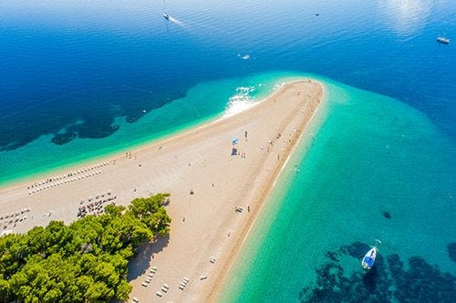 Zlanti Rat beach in Croatia, also called Golden Horn beach for the white sand triangle jutting into the ocean