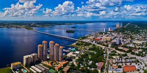 Aerial view of Fort Myers waterfront with high rise buildings and bridges stretching across the river