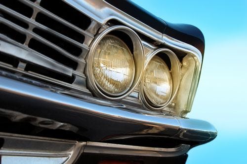 Close up of the headlamps of a vintage car