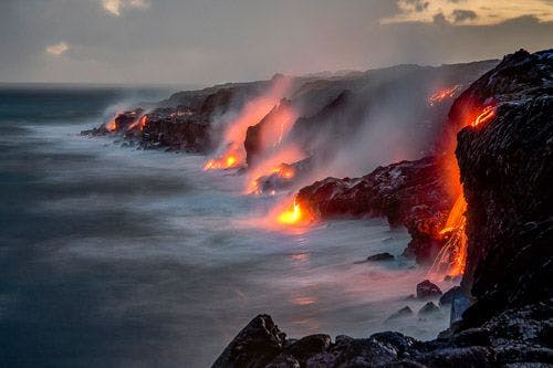 Lava from Hawaii volcanoes flowing over cliffs into the Pacific Ocean