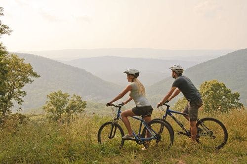 Two people cycling through the mountains on Virginia