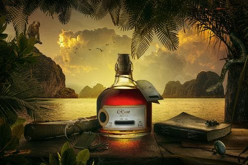 CGI of a bottle of Jamaica rum against aa ocean backdrop