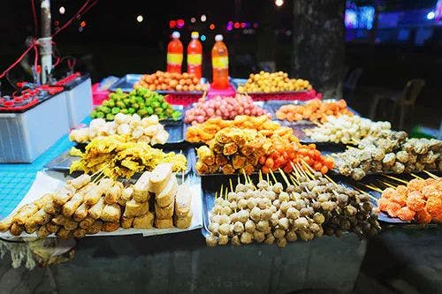 Heaps of food and snacks on a stall at a night market