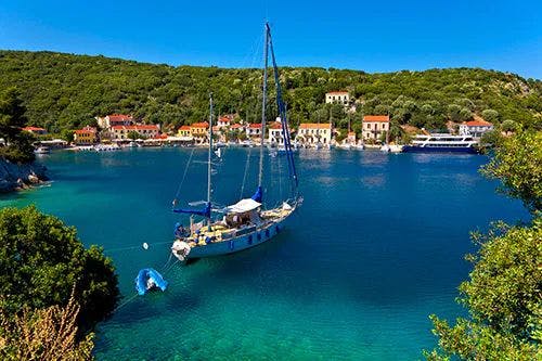 A sailboat moored in clear water on the island of Ithaca