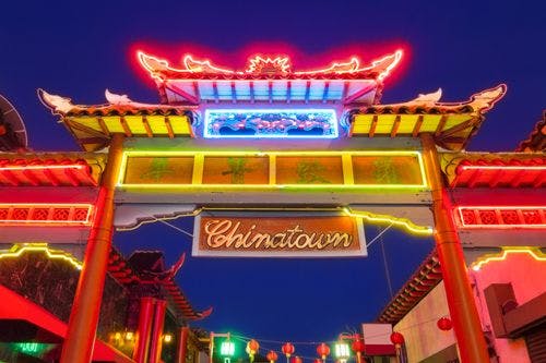 Chinatown entry gate lit in neon lights