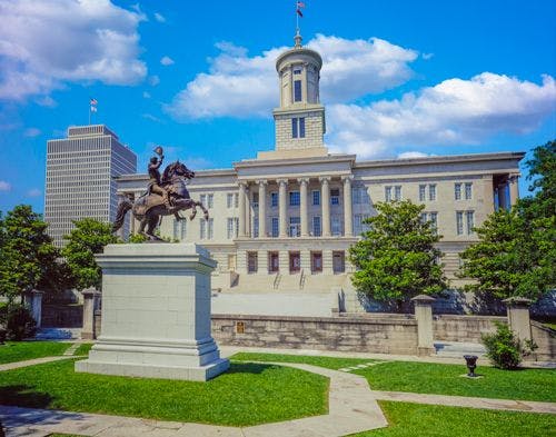 The Tennessee capitol building with a statue of a man on a horse out front