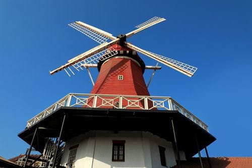 Old Dutch Windmill in Aruba, a red wooden windmill against blue sky