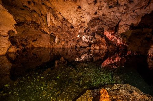 Inside Green Grotto Caves, with still water lake