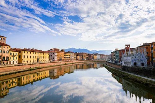 River Arno in Pisa reflecting buildings along the edge
