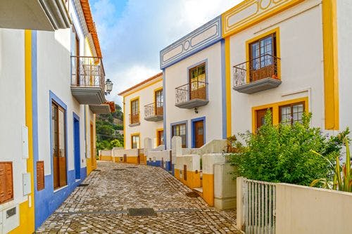 Small town with white, yellow and blue buildings in the Algarve