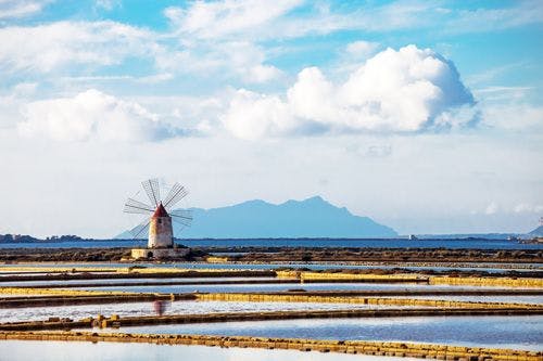 A windmill and salt flats in Sicily
