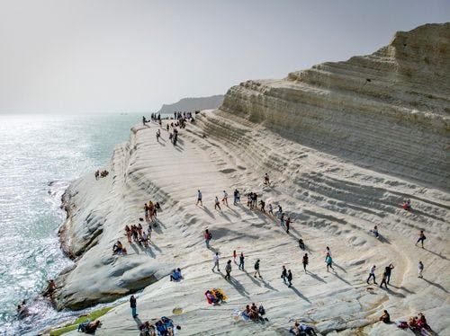 People standing on smooth white graduated cliffs in Sicily