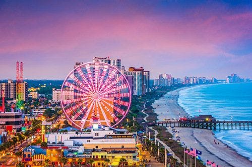 Myrtle Beach in South Carolina, a seafront resort with a boardwalk, ferris wheel, bars, and restaurants