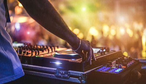 A DJ spinning the decks at a nightclub