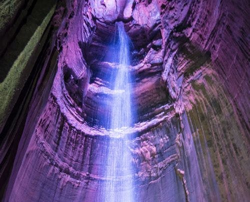 Ruby Falls, a cavern waterfall where the water and rock face is illuminated
