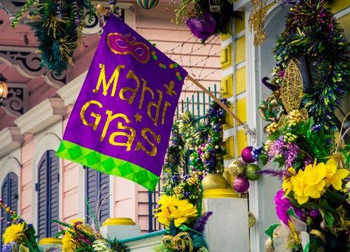 Mardi Gras flag hanging from a New Orleans building