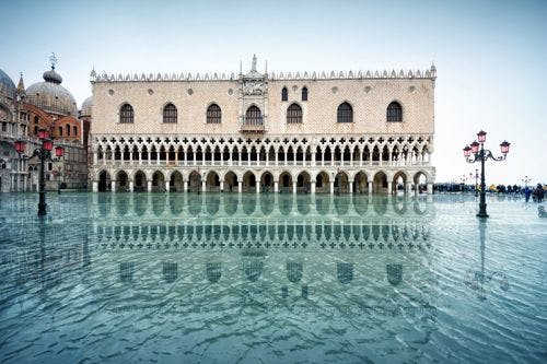 The Doge's Palace, a grand historic building, with high tide from the lagoon 