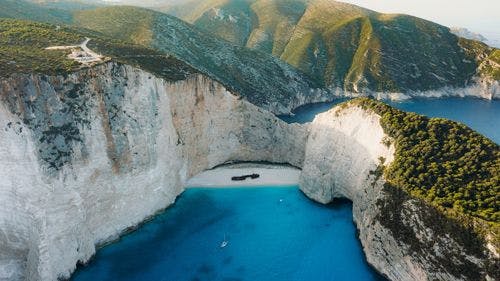 Aerial view of Navagio Beach with rusted shipwreck on the sand