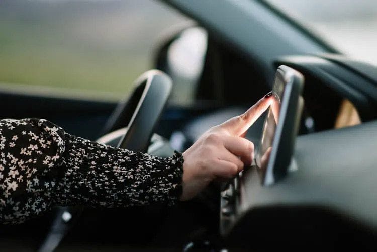 A woman using a GPS in a car