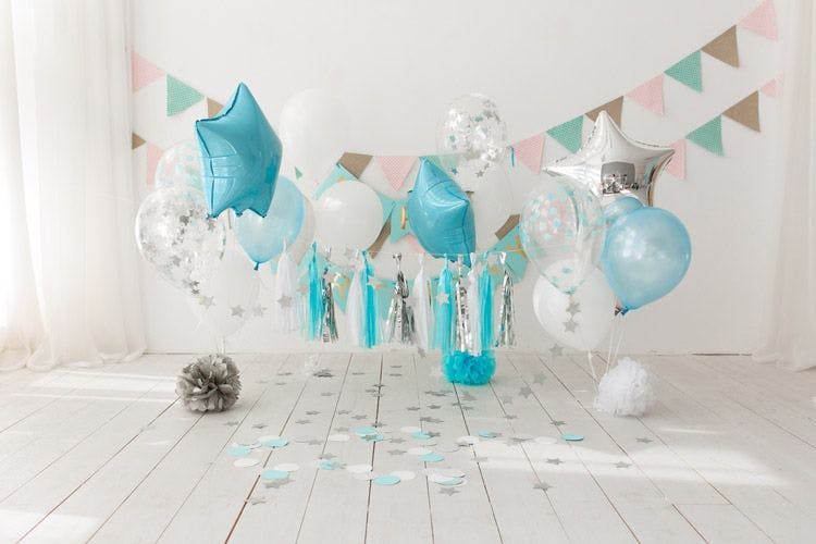 Party supplies including balloons and confetti and bunting