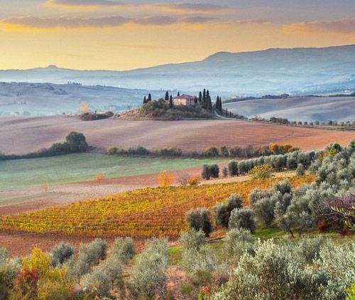 Misty morning over the rolling fields of Tuscany