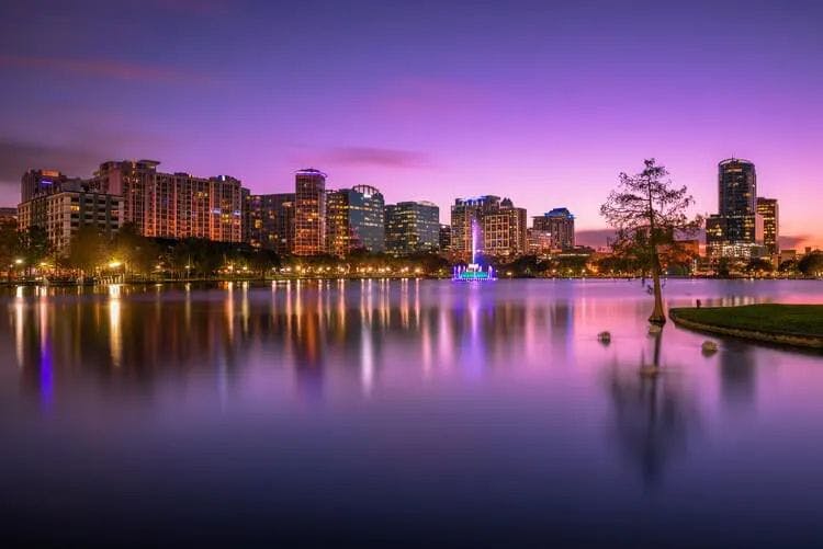 A purple sunset sky over Downtown Orlando and Lake Eola