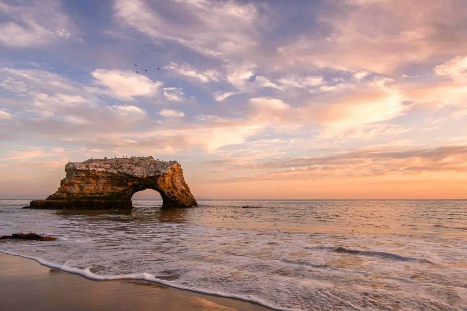 A rock arch n the sea in California