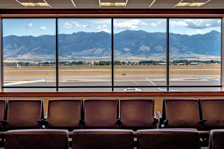 View from the windows of Bozeman Montana Aiport of the runway and Rocky Mountains in the background
