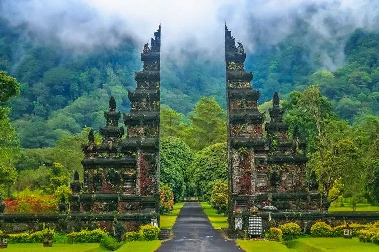 Temple gates in front of a rainforest