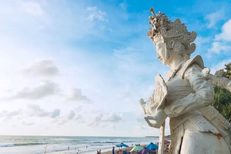 A statue of a goddess overlooking the sea