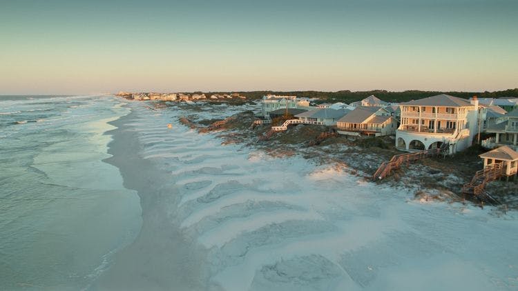 View of vacation homes on a white sand beach