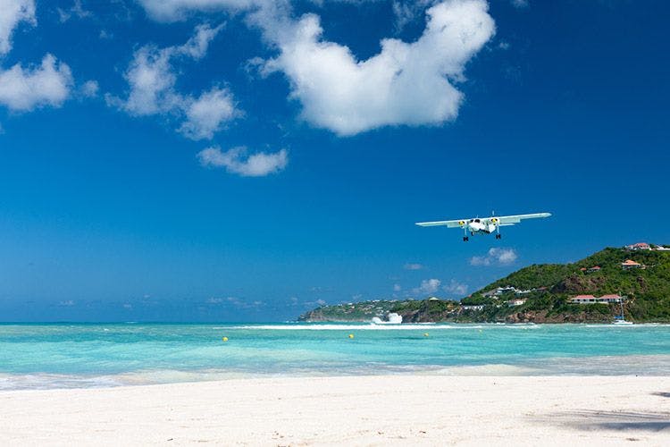 A small plane landing on Nikki Beach in St Barts