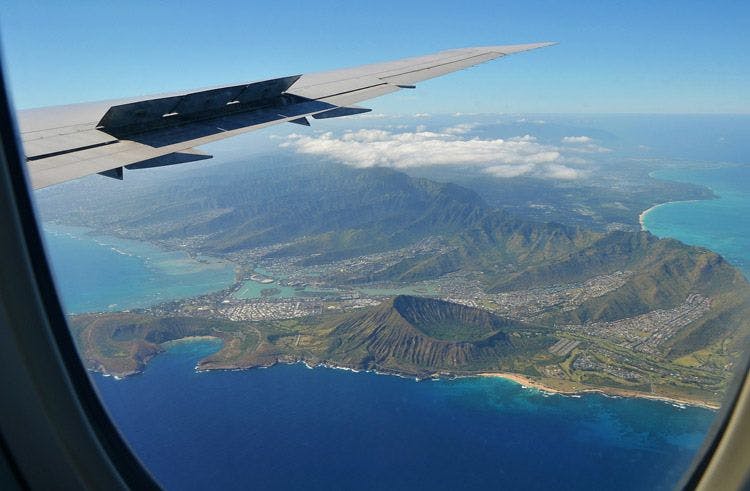 View of the coast and volcanic crater of Hawaii from the window of a plane